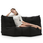 Modular bean bag corner in Black Sapphire with model lounging